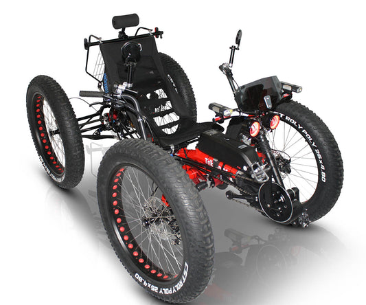 Front angled image of TrikExplor F426e showing offroad tires, headlights, and electric assist hardware integrated with the front crankset.