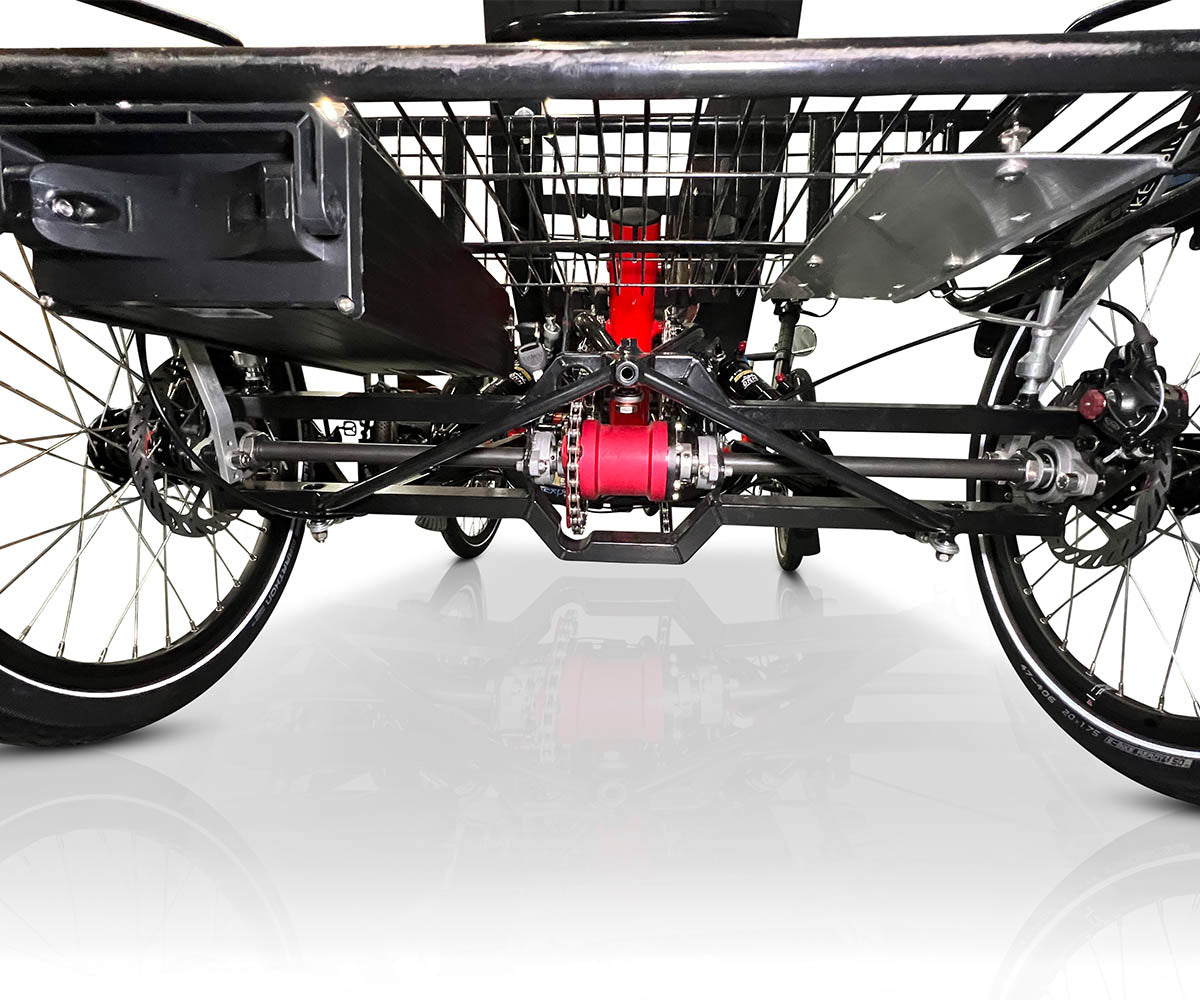 Close-up of the TrikExplor 420e's rear axle and suspension system, highlighting the drivetrain and rear disk brake system