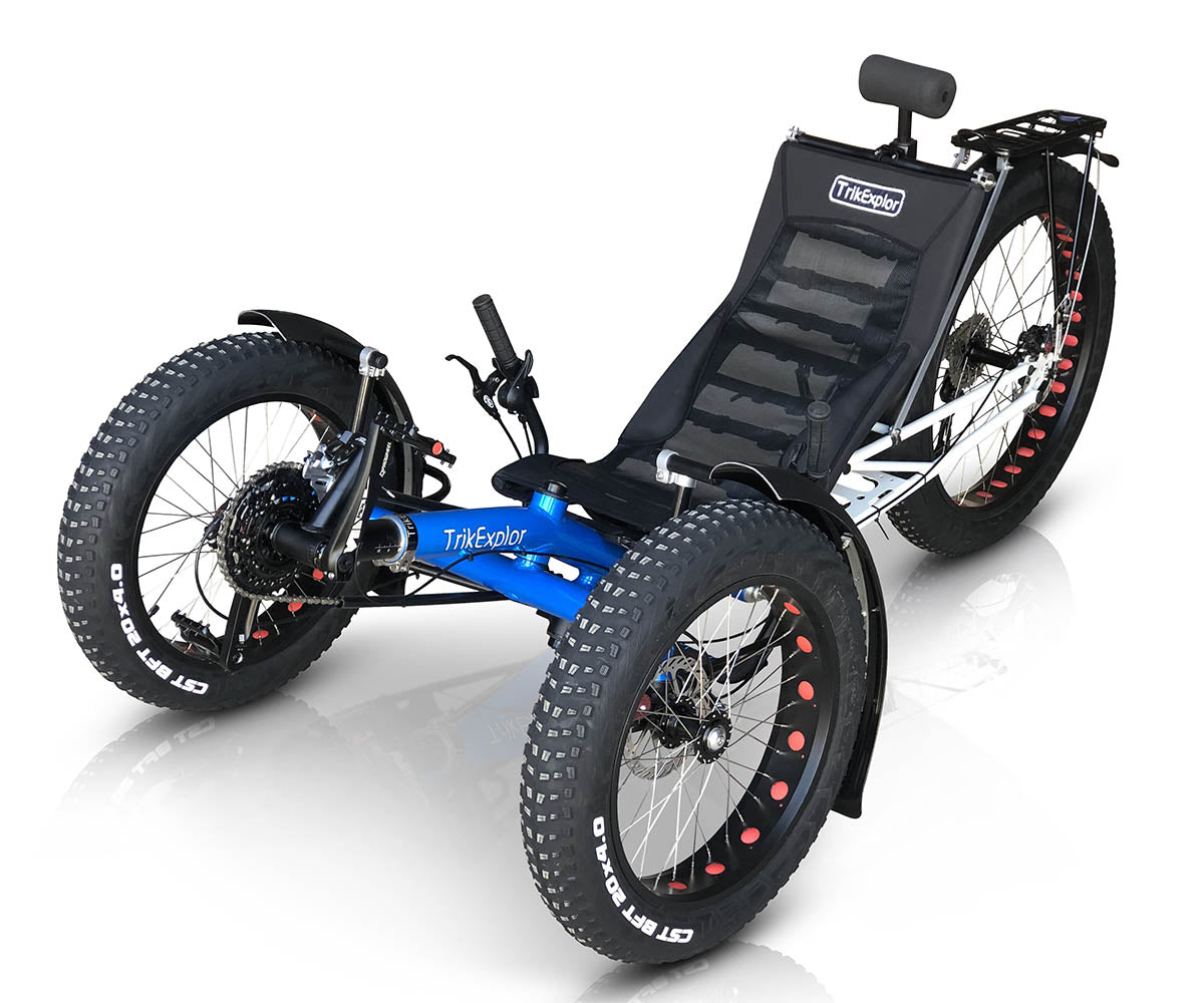 TrikExplor F326e with blue frame, three fat tires, and a reclining mesh seat. Front angled view showing the trike's full profile.