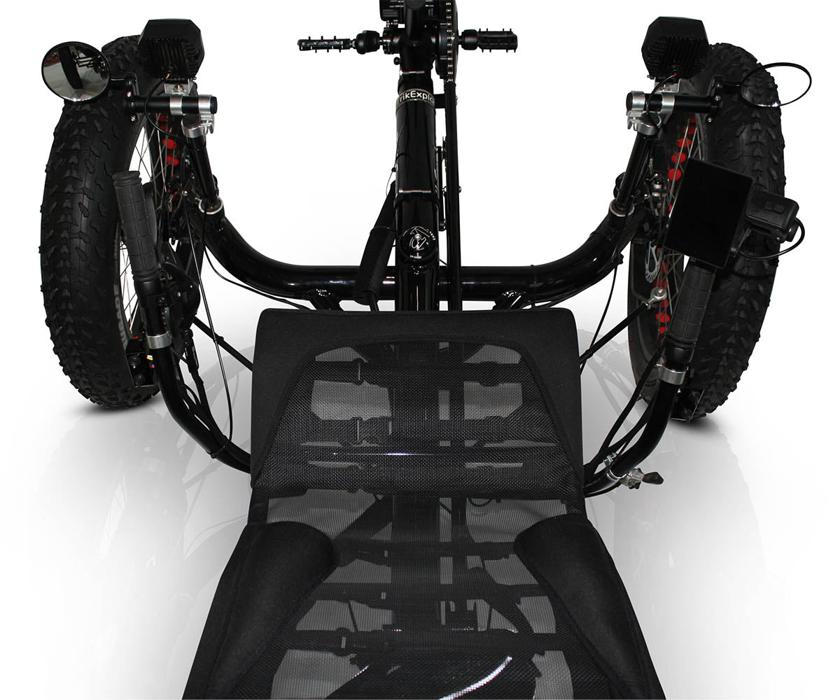 Top down view from the seat of the TrikExplor F420E recumbent electric assist quad showing handlebars, headlights, and crank set with motor.