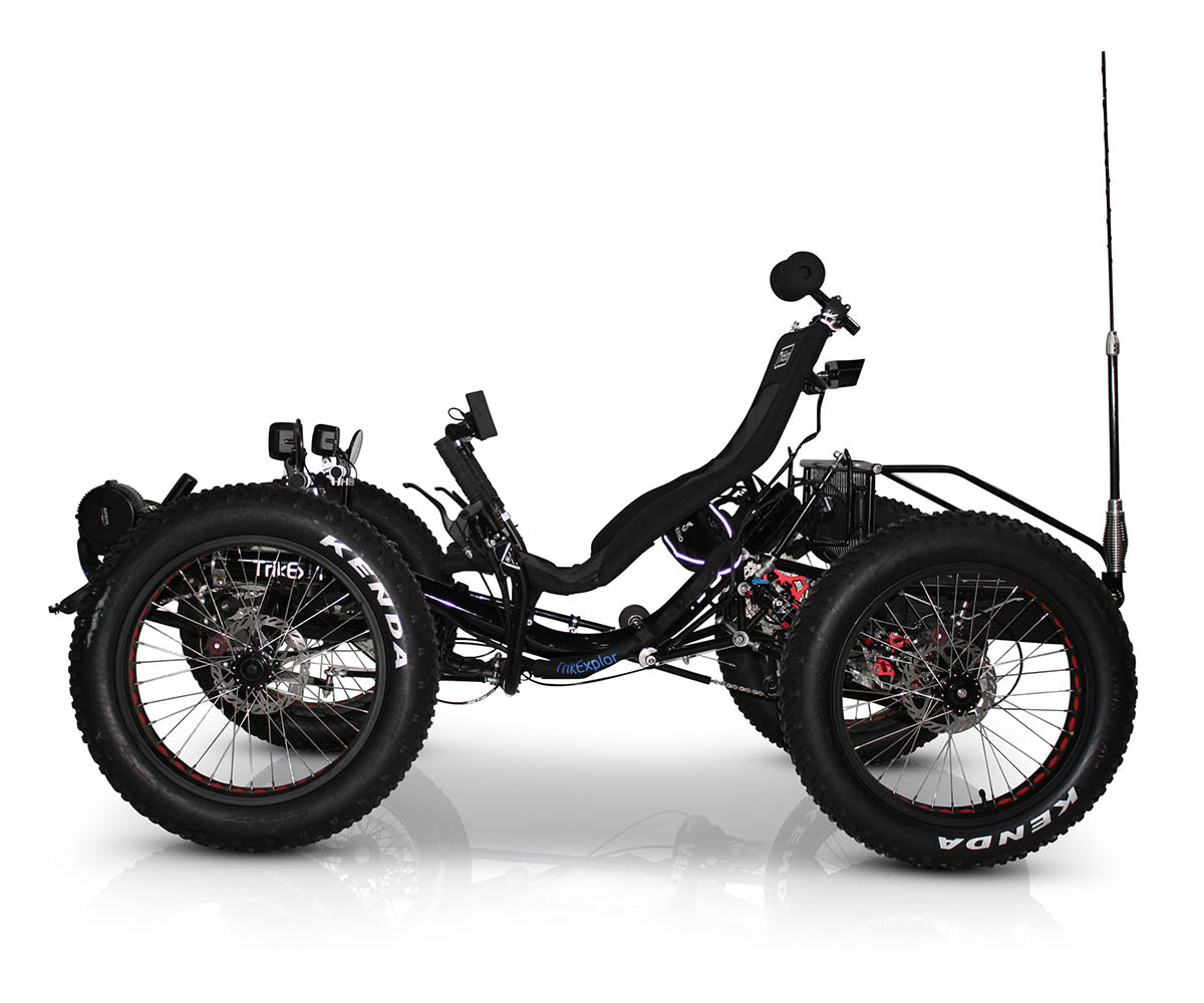 TrikExplor F420E recumbent electric assist quad fat off road tires, black seat, rear cargo rack, and flag.