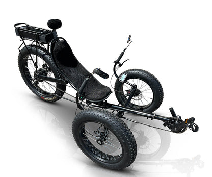 DuraTrike FX36e adaptive trike with off road tires and rear rack. Front left angled view showing the steel frame & crankset without pedals.