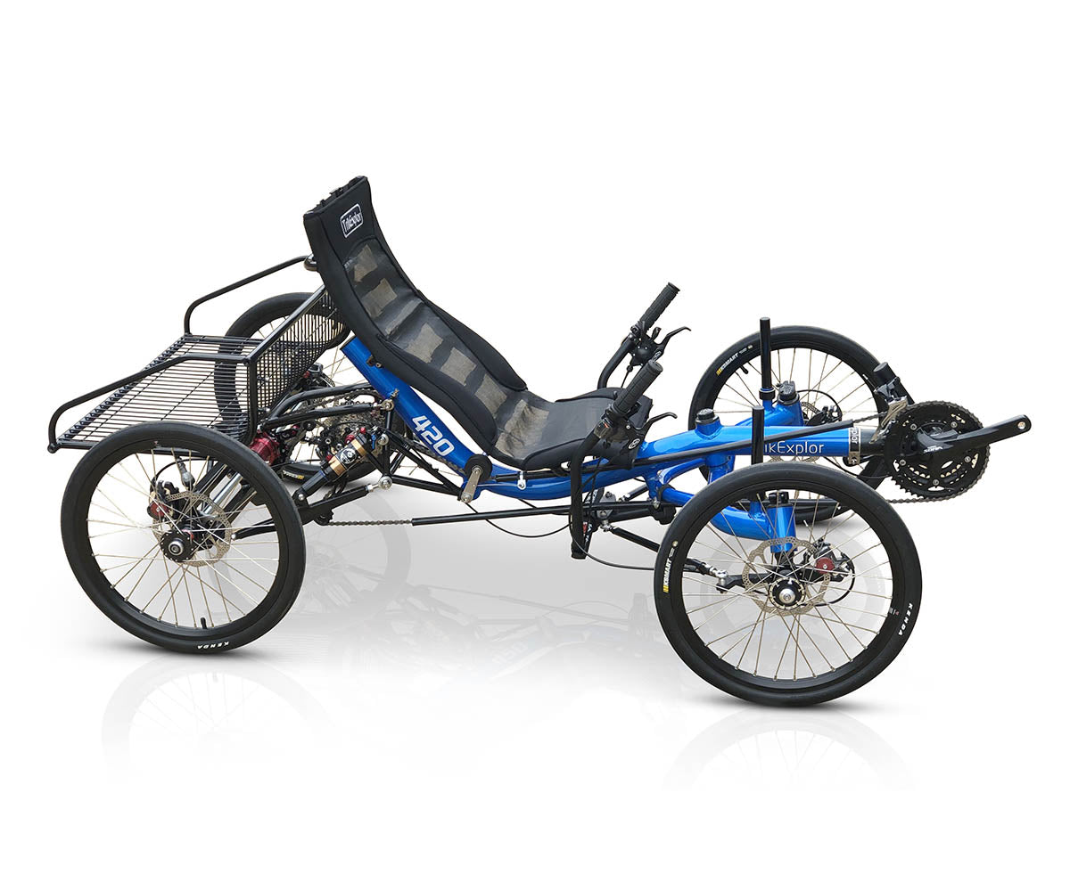 Side view of the TrikExplor 420 recumbent quad with blue frame and rear cargo rack, displaying the 3x9 rear gearing system and rear suspension