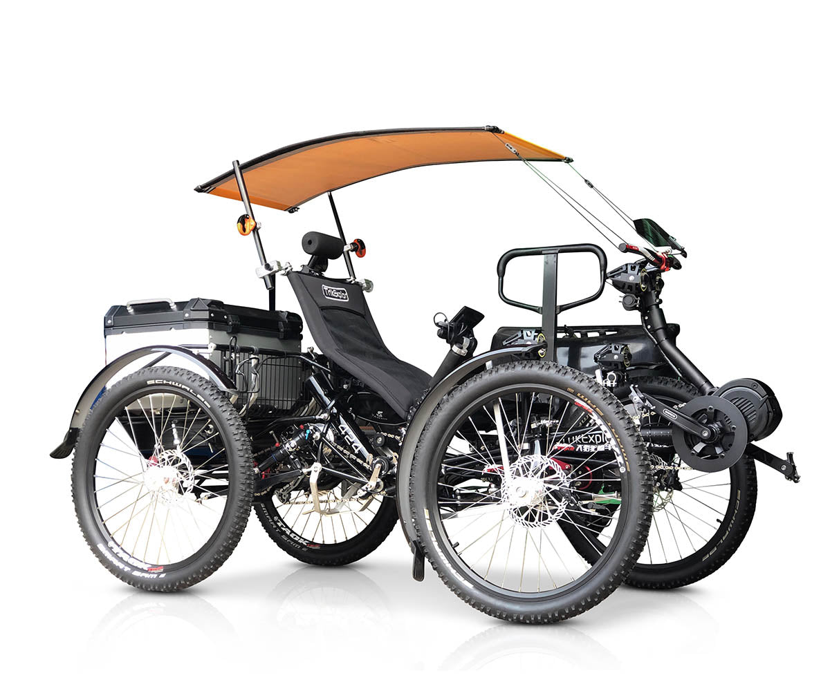 TrikExplor 424e recumbent electric assist quadricycle with all terrain tires, rear cargo box, and orange canopy, viewed from the side.