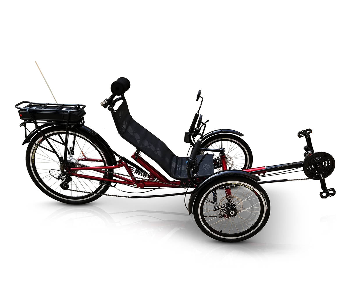 Side view of a TrikExplor FT36e red recumbent trike with black seat, three wheels, and a safety flag.