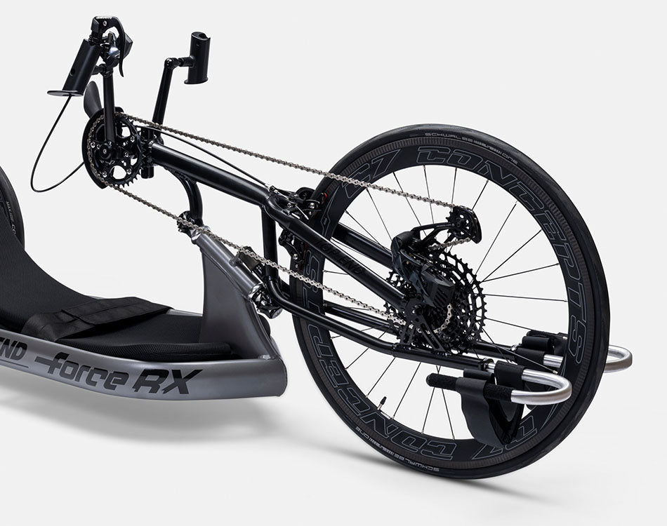 Top End Force RX handcycle focus image showing hand pedals, front wheel, and gearing